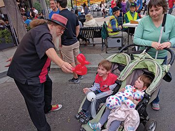 Ronit Mazzoni takes her children to a street fair. 