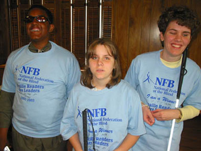 Paul Scruggs, Leah Grinder, and Jessice Watson show off their T-shirts at the Maryland Braille Are Leaders awards ceremony.  The students were among the thirty-five winners in the 2002-2003 contest.   A complete list of winners is publiched in this issue.