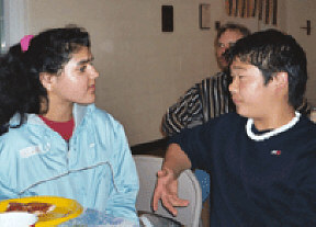 Blind teen, Nikki Singh understands the value of good listening skills as she and sighted teen, Isaac Powell, socialize at a church-sponsored dance