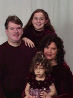 Stephanie Kieszak-Holloway with her family: husband Richard Holloway; daughter Kendra; and step-daughter Sarah (standing).