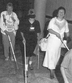 sighted kids pictured trying a cane. (20551 bytes)