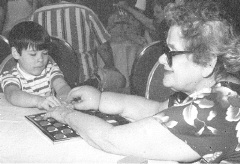 Michael Taboada and Mary Brunoli are shown playing checkers.(20278 bytes)