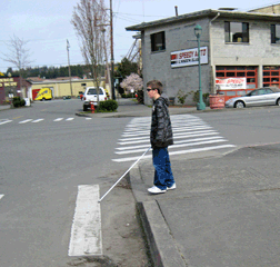 Orientation and mobility skills can only become effective if used consistently. Here, a fifth grader practices street crossings under blindfolds (sleepshades).