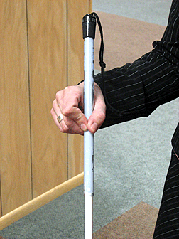 The pencil grip technique uses the thumb, index, and middle finger to manipulate the cane.