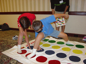 Blind and sighted students play together on the adapted Twister game.