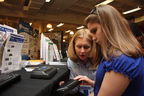 In the exhibit hall Colleen Wunderlich of Freedom Scientific demonstrates equipment to Shelby Craig of South Carolina.
