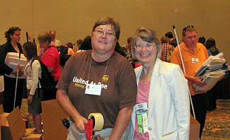 Barbara Cheadle and a UPS volunteer stand in the midst of the Book Fair pandemonium