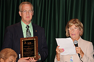 Cathy Jackson presents the 2011 Educator of Blind Children Award to Dr. Dean O. Stenehjem