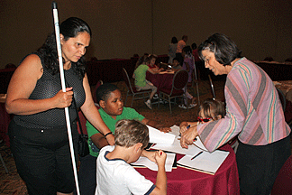 Ann Cunningham explains an art project to three children and an adult