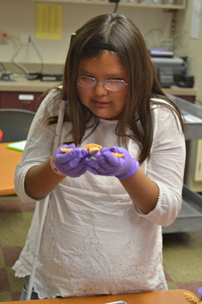 Arianna Benally carefully studies a dissected starfish during STEM2U Phoenix.