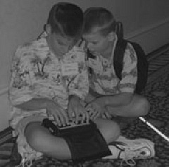 John Pastorus an Tommy Carrol discover a common interest in Technology at the 2001 Convention.