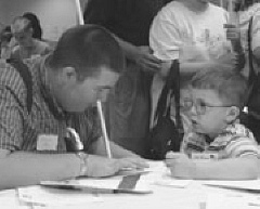 Nathan Clark (right) plays a Braille game with Patrick Ward at the Braille Carnival