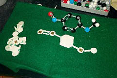 Tactile aids can be purchased from college book stores, such as the 3-D snap-together molecule set pictured upper right; and others, such as this felt bosrd with cardboard cut-outs, can be made with inexpensive materials.