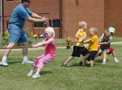 Kids play tug-of-war at the NOPB sponsored event at the 2002 convention.