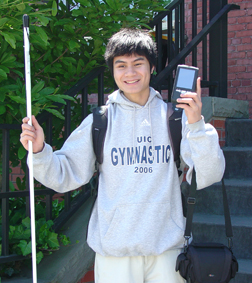 A young boy proudly holds up his new Reader