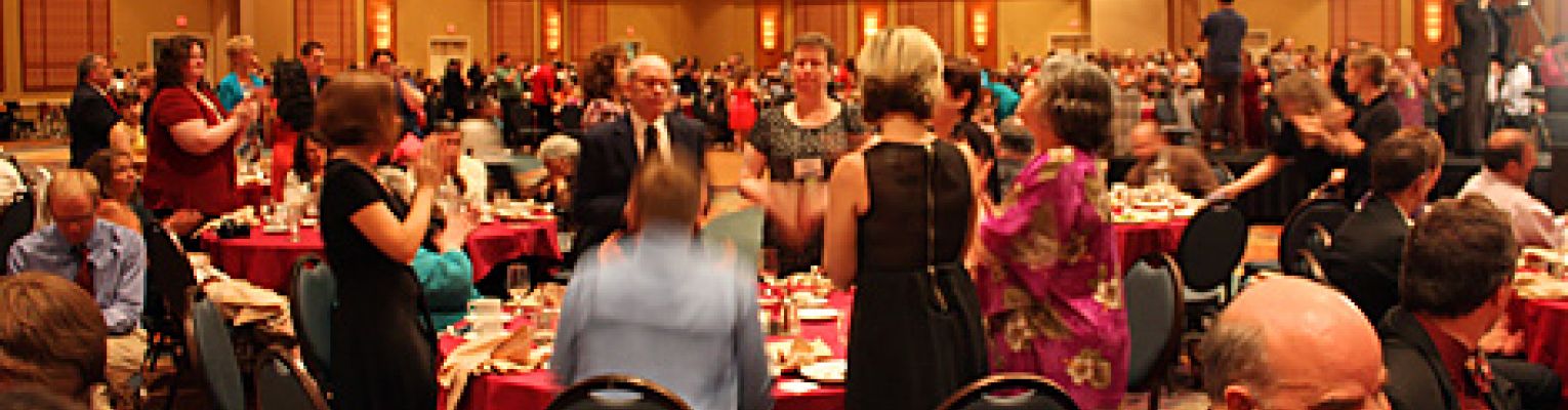 A crowd stands for a standing ovation at the national convention.