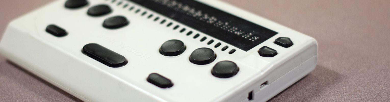 The Innovision Braille Me device rests on a table.