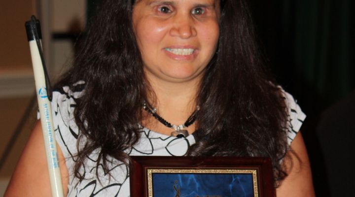 Michelle Chacon smiles with the Blind Educator of the Year award