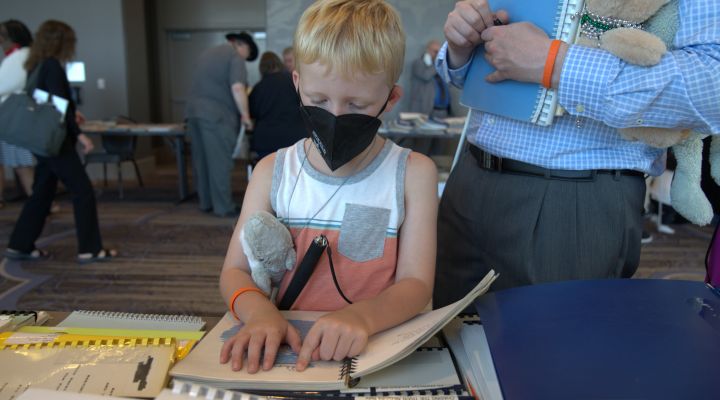 A blind child reads a Braille book
