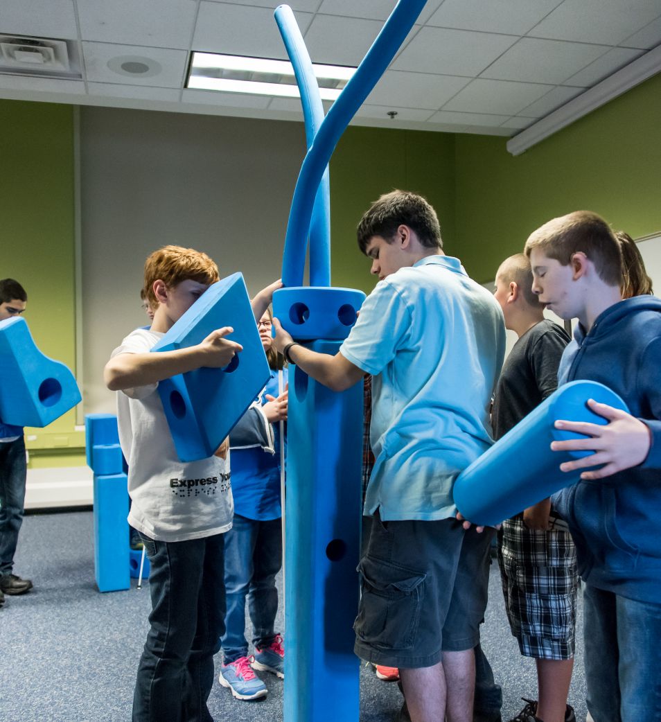 Blind youth build a tower of blocks