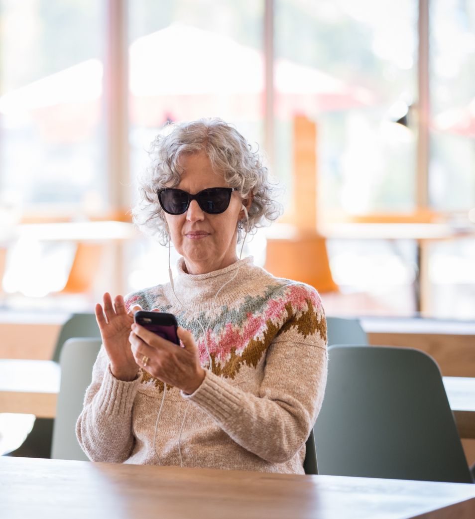 A A blind woman scrolls through her phone