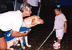 Mikaella Besson saying hello to a guide dog.