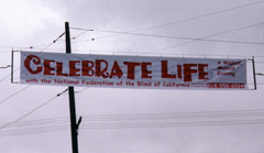 this banner was flyingover one of the busieat intersections in Burbank, California, the day of the NFB of California's wine and cheese reception and silent auction.  The event was also a highly successful effort to educate the publicc about the many programs of the National Federation of the Blind.