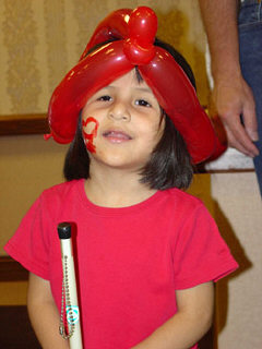 Mylene Richardson of North Carolina shows off her balloon hat, her face painting, and her white cane.