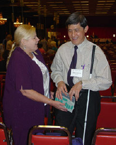 Kicki Nordstrom, laughing, holds an electronic notetaker while Kua Cheng Hock examines it.
