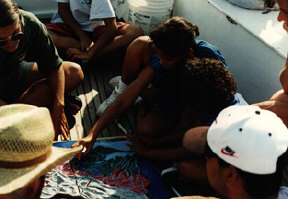 Tactile materials and exploration are essential to effective science learning for blind youth.  This group of students examine a tactile map of the Chesapeake Bay as the Living Classrooms sailing ship takes them out for more hands-on learning.