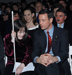 Seated together in the audience, Courtney Despeaux listens to Baltimore Mayor Martin O'Malley.