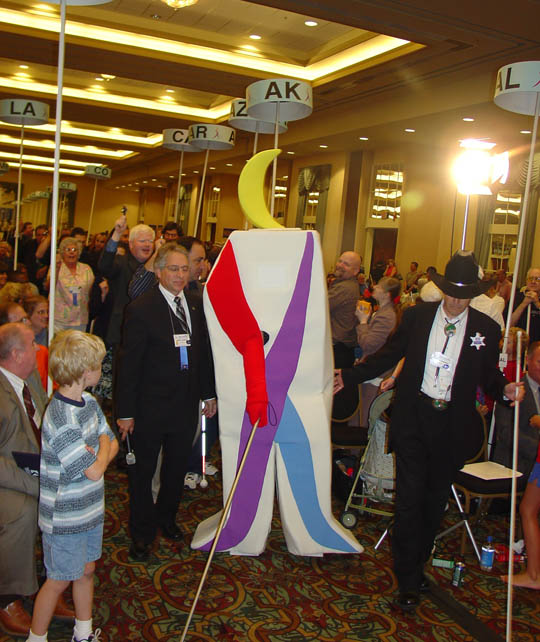 At the close of Kevan Worley's stirring address about the Imagination Fund Tuesday afternoon, Whozit entered the convention hall and made his way to the front.   He was seven feet tall and sported all of his bright colors.   Whozit may be said to be vocal without being verbal.  His only word was a falsetto "Who-who, who-who."