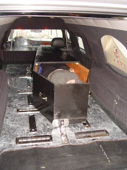 A hearse prepares to drive away carrying Rosy Carranza�s body in a casket.