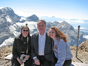 Mary Ellen Jernigan, Marc Maurer, and Dianna Maurer are seated with the Alps visible behind them.
