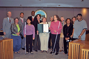 Maryland Federationists accept a proclamation for White Cane Safety Day from members of the Howard County Council. Pictured here (left to right) are Jim Roth, Karen Herstein, Greg Fox (Howard County Council member),&nbsp;Amy Herstein, Calvin Ball (Howard County Council member), Courtney Watson (Howard County Council chairperson), Darlene Barrett, Mary Kay Sigaty (Howard County Council member), Lydia Roth, Sharon Maneki, Kim Peyton, Jen Terrasa (Howard County Council member), and D. Swanston-Williams.