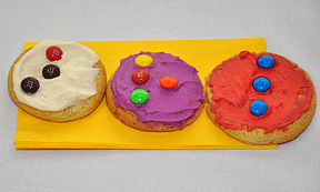 The refreshments at the celebration were frosted sugar cookies, each with a Braille letter made of M&Ms. Here the three letters, B, R, L, spell Braille.