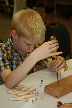 Student Luther using a screw driver�to learn how a screw works as a simple machine