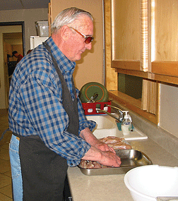 Darryl Hale washes dishes at the Colorado Center kitchen sink.