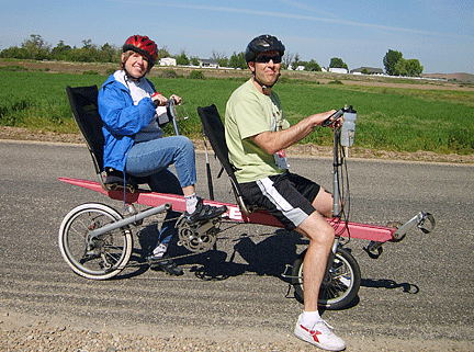 A tandem bike team pauses along a country road
