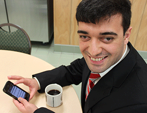 Nijat with his morning coffee and NFB-NEWSLINE on his iPhone