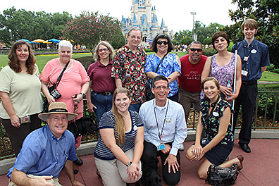 Members of NFB Travel and Tourism Division and Disney cast members posed in front of Cinderella&rsquo;s castle. Back row left to right: Maureen, Margo Downey, Jo Taylor, Milt Taylor, Cheryl Echevarria, Nelson Echevarria, Anahit Labarre, Greg. Front row: Nicole, Mark Jones, Catherine