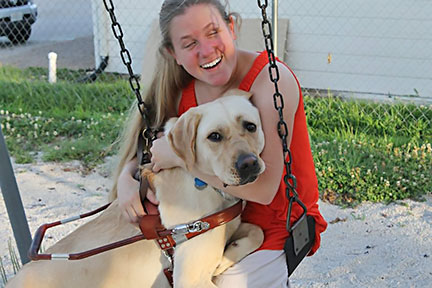 Julie McGinnity hugs Bill the guide dog
