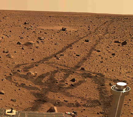 The picture taken by the Mars Rover shows the pristine Martian vista marred by tracks left by the Rover.