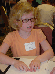 Megan Palmer reads a Braille word puzzle at the Kenneth Jernigan Braille Carnival.