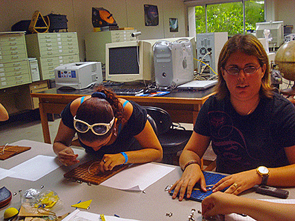 Gathered around a table, students use the tactile Cartesian plane 