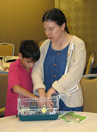 What&rsquo;s in the cage? Heather Field encourages a young boy to find out.