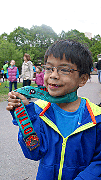 Jayden proudly holds up a racing ribbon.