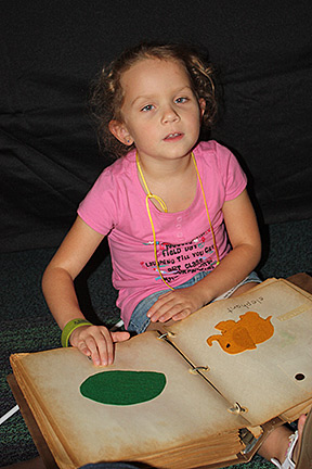 Faith Switzer with a large Braille book