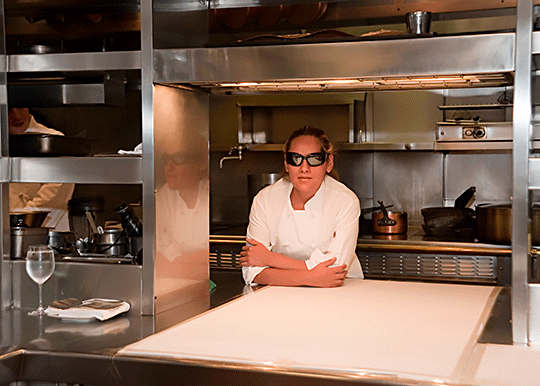 Laura Martinez stands in a commercial kitchen.