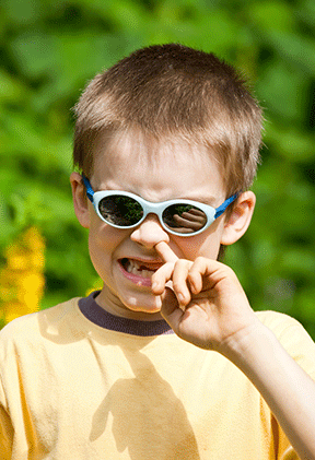 A young boy picks his nose--an example of why manners matter.